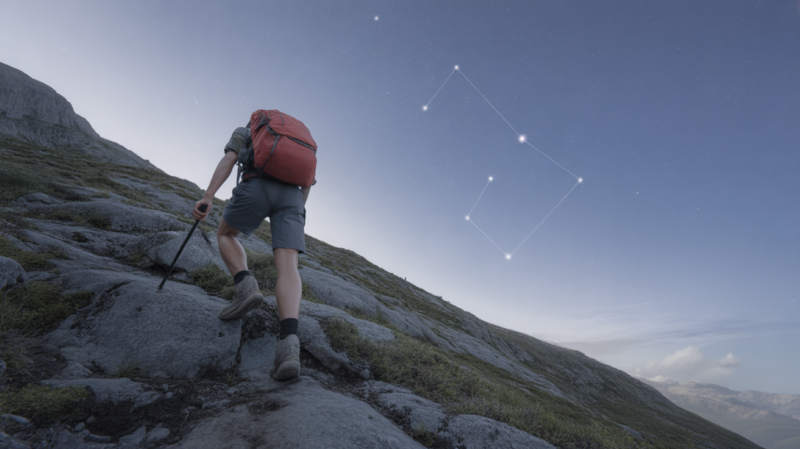 Personne réaliste gravissant une montagne au lever du soleil, symbolisant l’ambition et la persévérance du signe du Capricorne.